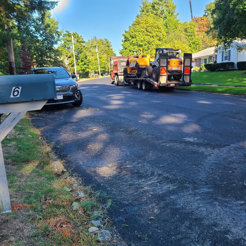 EJ Lopez paving equipment arriving at a job