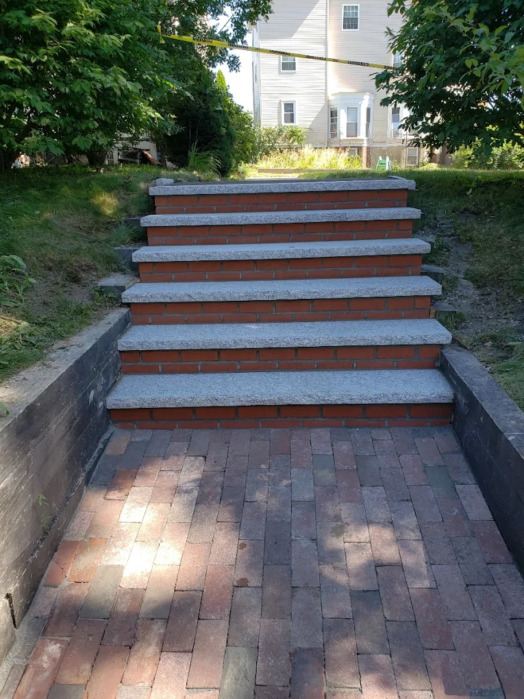 Brick and granite steps with paver landing